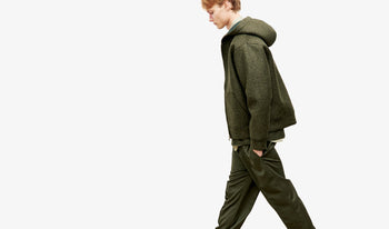 A.P.C. Men's Sweatshirts & Hoodies - Man wearing white t-shirt and striped jacket standing in front of house steps.