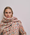 A.P.C. Gift Me More - a woman model wearing a colorful sweater against a plain background