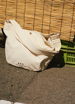 White Journal bag on concrete floor
