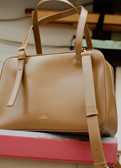 Box bag sitting on edge of table