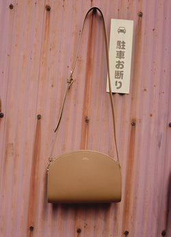 A.P.C. Demi Lune bag hanging on shipping container