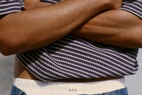 Man wearing striped t-shirt with crossed arms