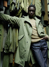 A.P.C. Journal - Man wearing green parka and blue jeans.