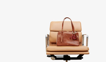 A.P.C. Women Sale Bags - Woman and man sitting together wearing coat and jeans.