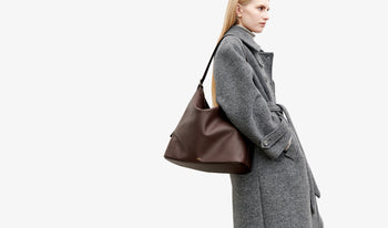 A.P.C. Women Sale Coats, Jackets - Woman wearing ecru coat and black Grace bag.