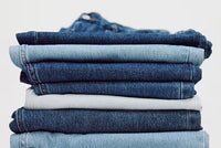 A.P.C. Denim Care Guide - Stack of jeans.