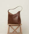 A.P.C. Bags - brown leather bag sitting on a stool
