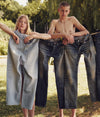A.P.C. Denim - woman and man model standing behind a clothesline with jeans hanging