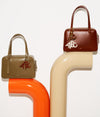 A.P.C. handbags sitting atop tubes