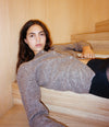 A.P.C. New Arrivals - woman in fall 26 outfit laying on stairs