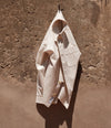 A.P.C. men's shirt draped over a hook on a rock 