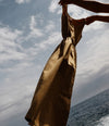 A.P.C. dress in the air against a body of water backdrop