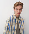 A.P.C. man posing in Fall 26 collection outfit
