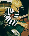 A.P.C. Brain Dead - a guy playing guitar in a studio