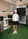 A.P.C. Golf - woman standing in a golf store