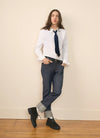 Man model leaning up against a wall in A.P.C. clothes