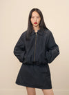 Woman model standing in front of a light background in A.P.C. clothes