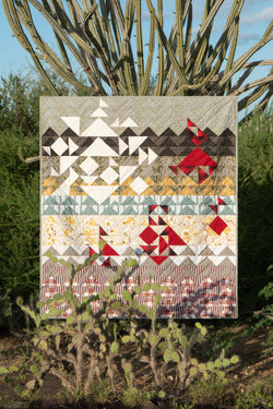 Quilt suspended among plants in jungle