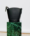 A.P.C. Grained Leather - Black Ana bag on stand.