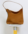 A.P.C. Suede - Brown Vera bag on stand.