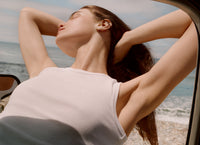 Woman relaxing with eyes closed on a beach