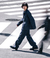 A.P.C. Fragment - man crossing a busy street in full denim look