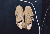 A.P.C. x Clarks Interaction - Desert boots next to audio wire.