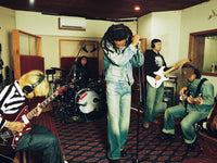 A.P.C. Brain Dead - a band in a studio wearing the A.P.C. x Brain Dead outfits
