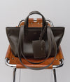 A.P.C. bag on a leather chair