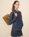 Women standing in all denim outfit with a shoulder bag